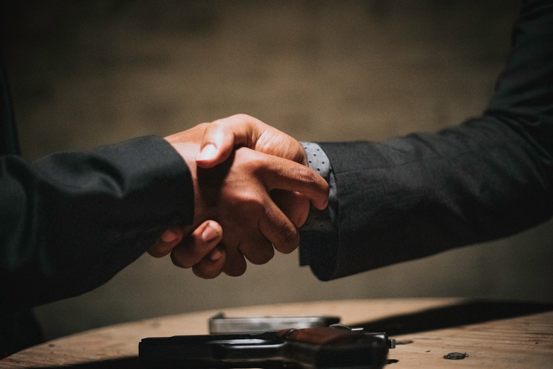 Government official shaking hands with AI executive in sleek data center, holographic policy interface floating between them, cool ambient lighting, server racks in background, professional diplomatic