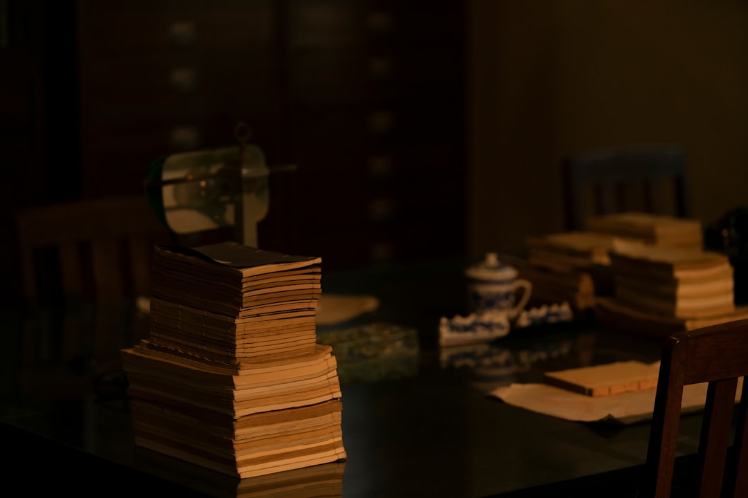 Professional lawyer overwhelmed by stacks of legal documents in dimly lit traditional office, contrasted with sleek holographic interface showing digital transformation potential, moody ambient lighti