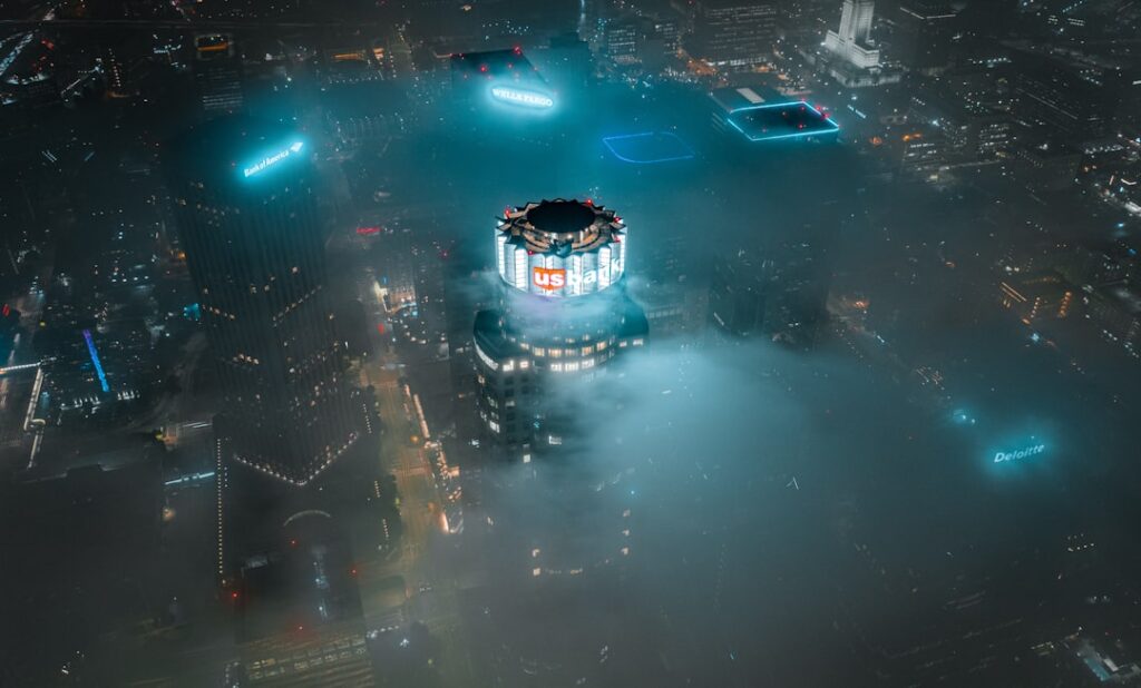 Aerial view of massive futuristic data center campus at night with glowing blue server lights, Chinese flag hologram overlay, professional tech infrastructure, ambient cool lighting, sleek modern arch