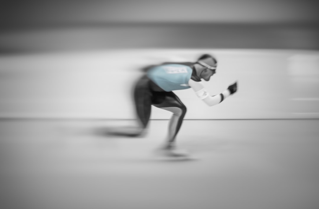Athlete mid-swing captured in frozen motion with computer vision tracking points overlaying body, trajectory lines and biomechanical data streaming in real-time, dark sleek environment, holographic bi