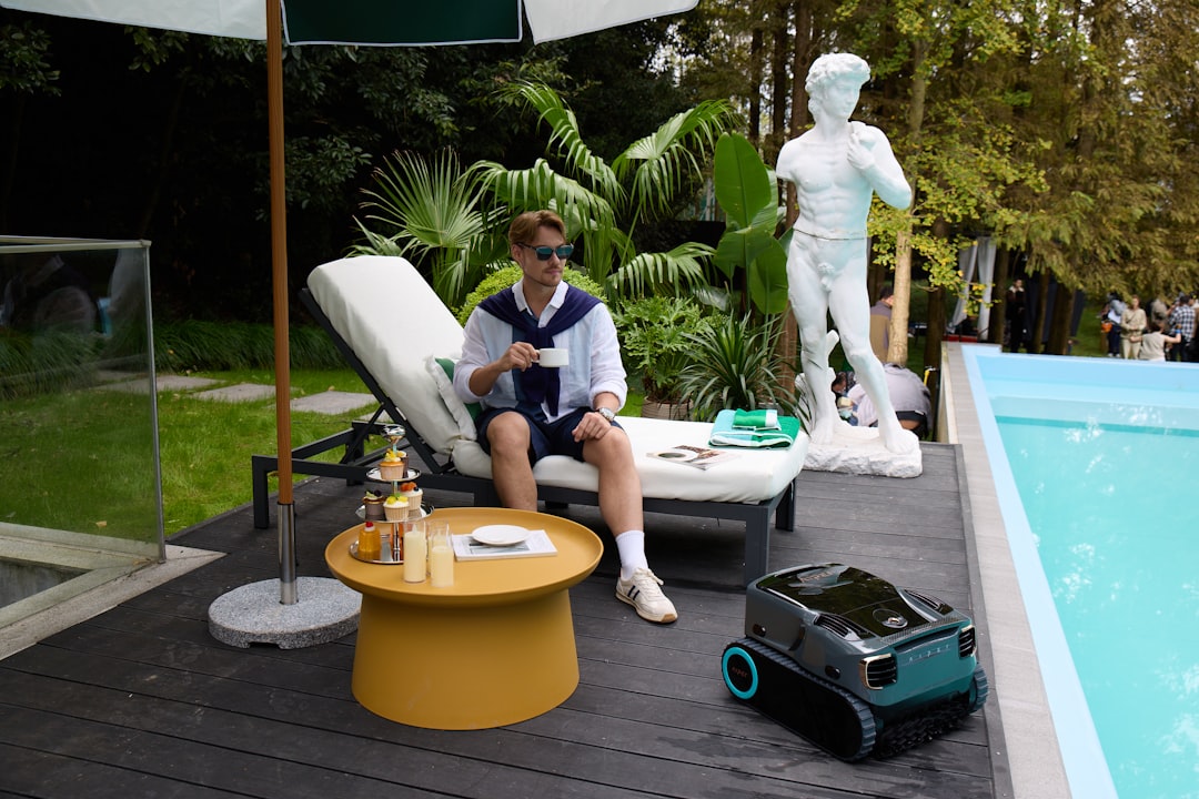 Human-robot collaboration in premium tech headquarters, diverse professionals celebrating success, holographic market growth charts, warm golden ambient lighting, futuristic corporate environment