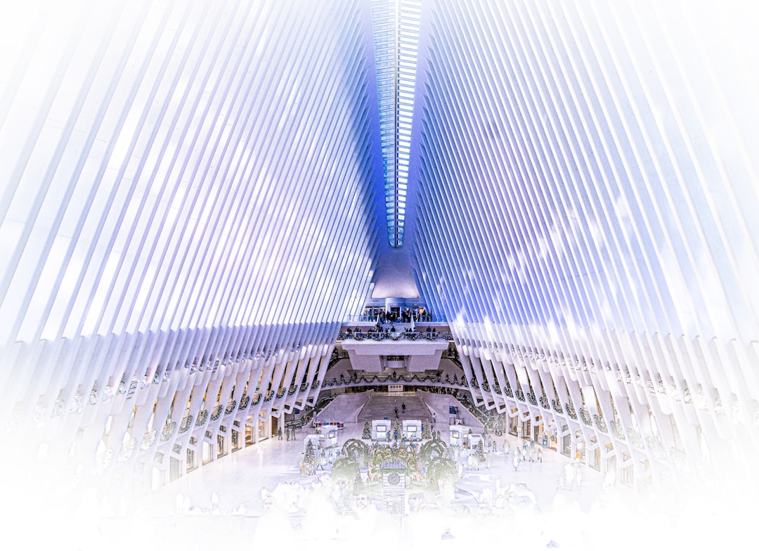 Futuristic New York courthouse interior with holographic legal documents floating above sleek wooden bench, ambient blue lighting, professional robed figure examining neural network visualization on t