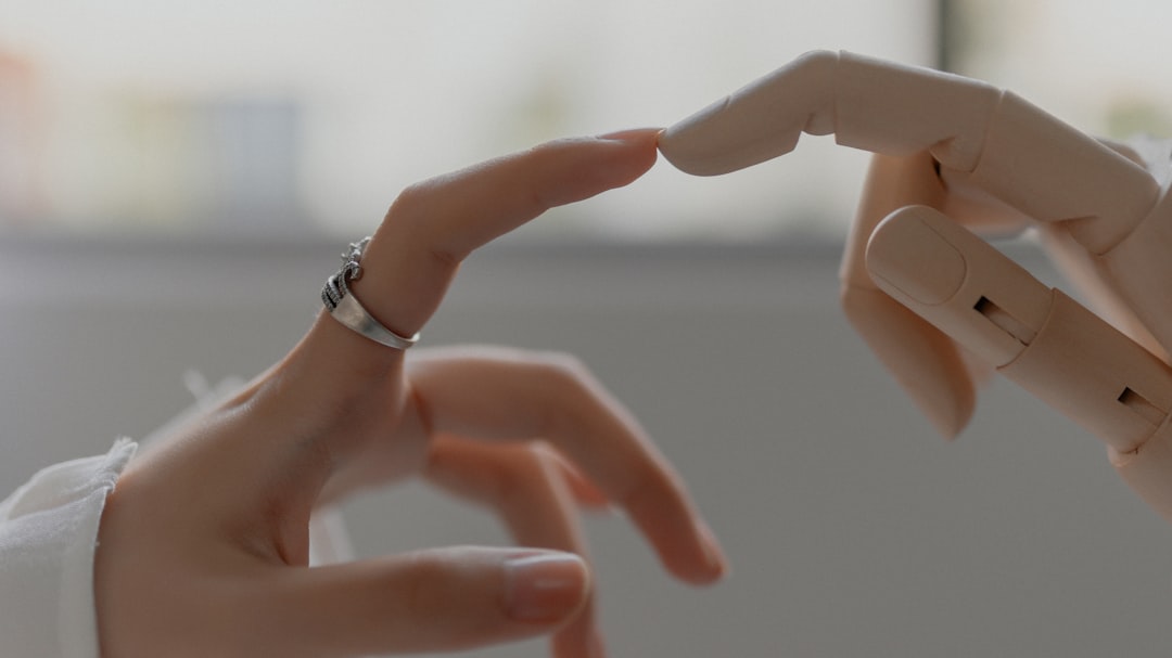 Futuristic medical AI robot hand gently touching human hand in soft clinical setting, warm and cool contrast lighting, hope and innovation mood, sleek biotechnology environment, human-machine harmony
