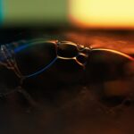 Futuristic transparent smart glasses on reflective surface with holographic data projections, executive silhouette in background, cool blue ambient lighting, corporate transparency concept