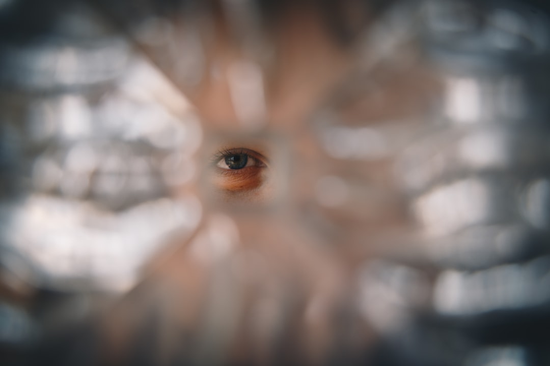 Close-up of human eye with neural network overlay reflected in iris, dark background with glowing synaptic connections, medical AI concept, cool blue and purple ambient lighting, scientific precision