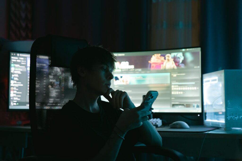 Overwhelmed professional staring at multiple glowing screens in dark office, information overload, blue ambient light, scattered data visualizations, stress and chaos