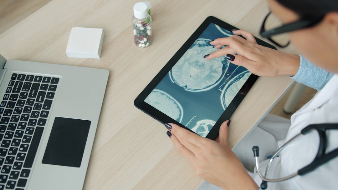 Medical AI professional analyzing holographic molecular spectroscopy data on transparent display, hospital corridor background, cool teal and white lighting, sleek futuristic healthcare technology set