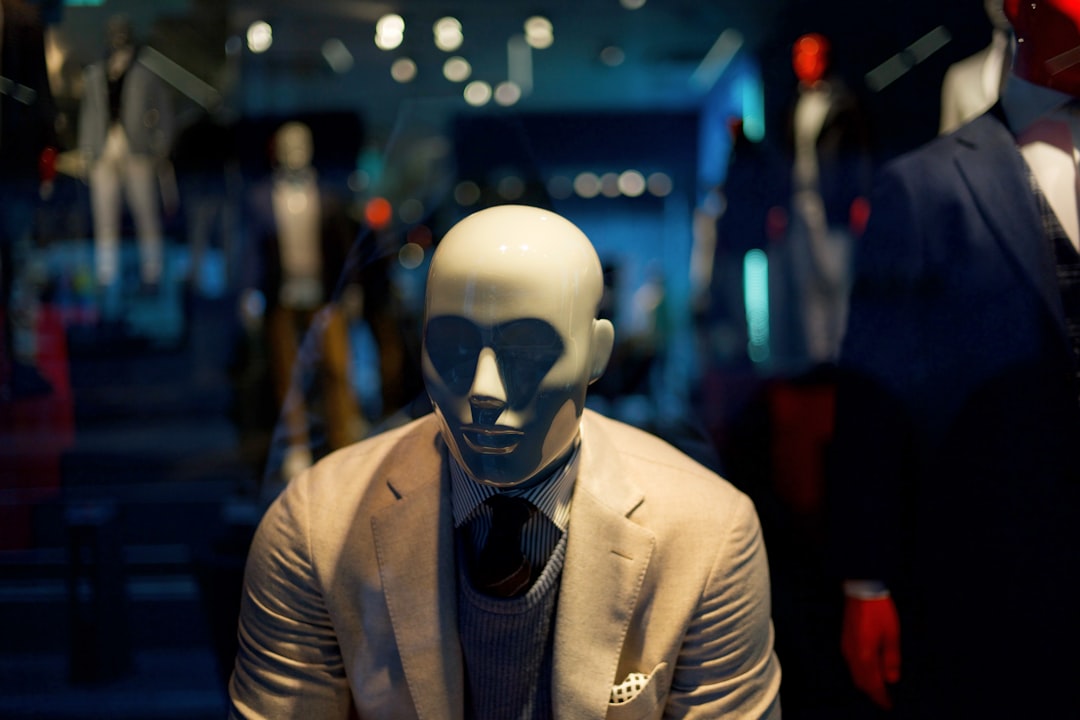 futuristic humanoid robot and business professional collaborating at sleek holographic display, ambient blue lighting, clean modern office, neural network visualization floating between them, cinemati