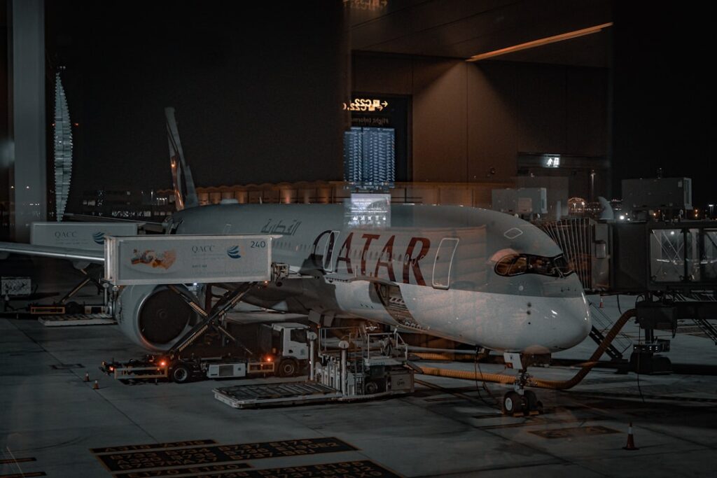 Futuristic Airbus aircraft hangar with holographic AI interface overlay, professional engineers collaborating, sleek ambient lighting, data visualization screens, sovereign technology concept, clean m