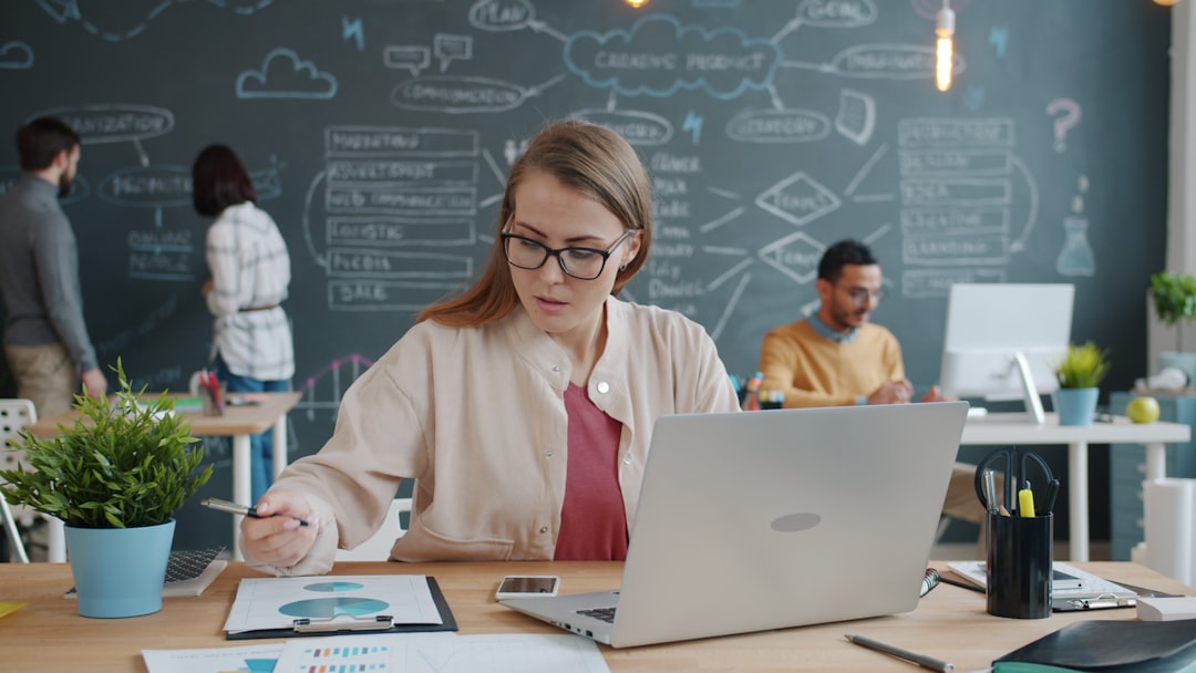 Professional woman holding glowing holographic microchip certificate, sleek corporate environment, futuristic digital badge overlay, ambient teal and gold lighting, achievement and career growth conce