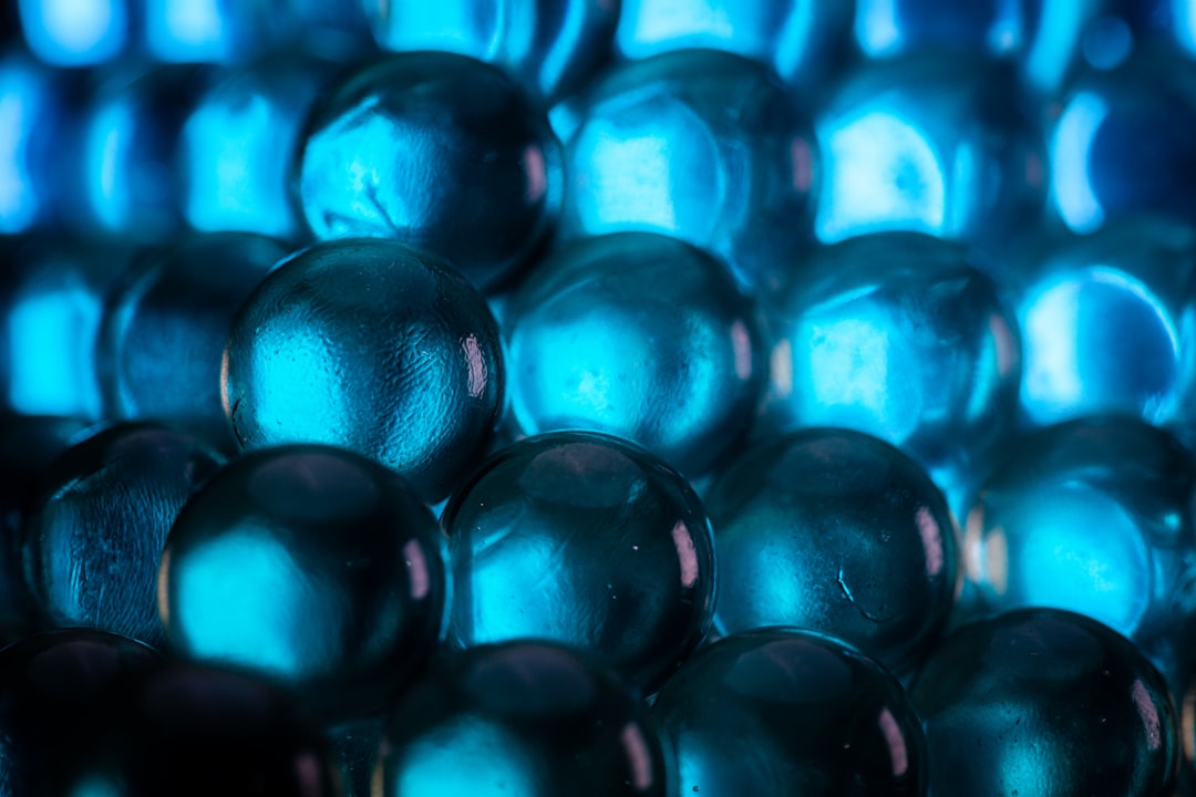 Macro shot of translucent molecular structure with neural network visualization overlay, generative AI nodes pulsing in cyan and magenta, dark background, professional medical technology aesthetic