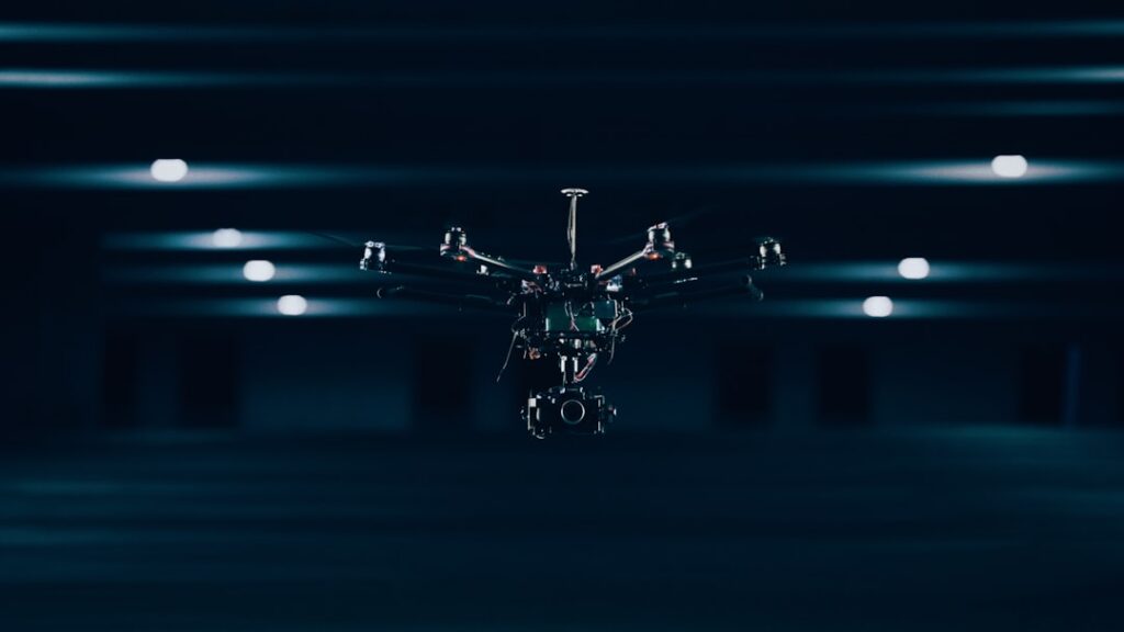 Futuristic smart factory floor with sleek robotic arms assembling components, holographic data overlays, ambient blue LED lighting, professional engineer monitoring production, clean modern industrial