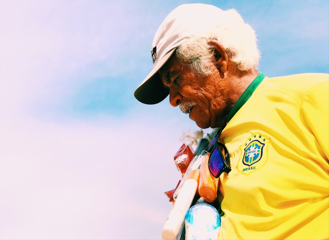 Brazilian soccer personality on authentic stadium broadcast set, genuine fan connection moment, warm golden hour lighting blending with professional LED screens, candid documentary style in premium sp