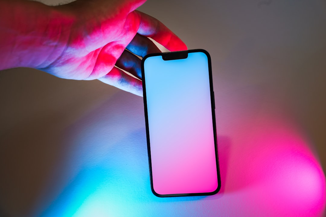Futuristic AI assistant hologram emerging from sleek smartphone, ambient blue light, clean modern office background, human hand reaching toward glowing neural network visualization, professional tech 