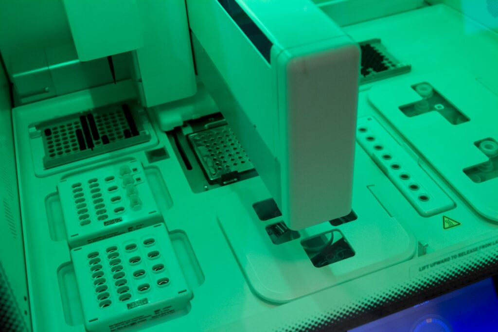Futuristic medical lab with holographic DNA strands floating above sleek workstation, doctor interacting with neural network visualization, cool blue ambient lighting, clean modern office