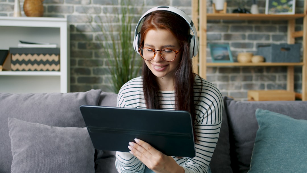 Personalized learning AI interface on tablet, young student smiling at adaptive educational content, warm ambient lighting in modern minimalist classroom, holographic data streams surrounding engaged 