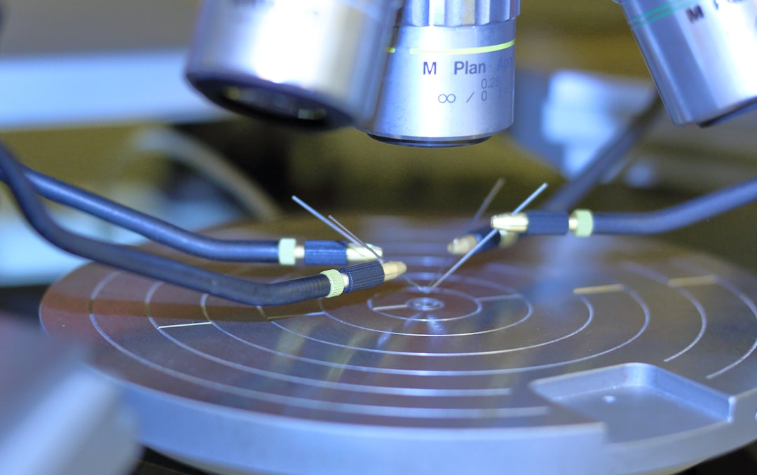 Extreme macro of robotic precision gripper attempting to thread microscopic needle, visible tension and imperfection, dramatic side lighting revealing complexity, shallow depth of field, abstract repr