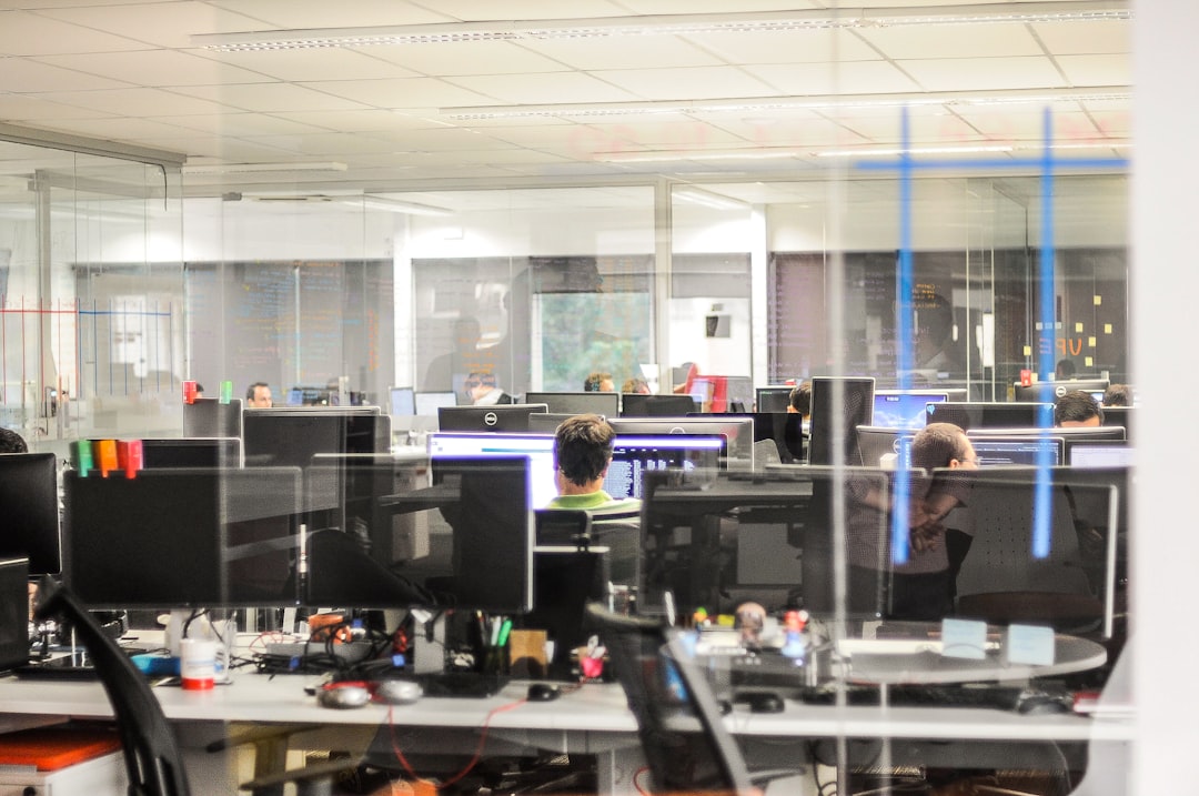 Professional Brazilian business team collaborating with holographic AI agent interface in clean modern office, sleek glass surfaces, warm ambient lighting, futuristic transparent displays showing auto