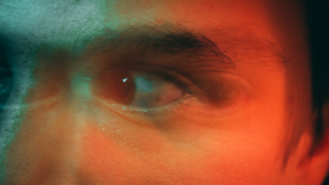 Close-up of ophthalmologist using sleek holographic eye scan interface, futuristic ambient lighting, neural network visualization overlaying retina scan, clean modern medical lab, professional tech ae