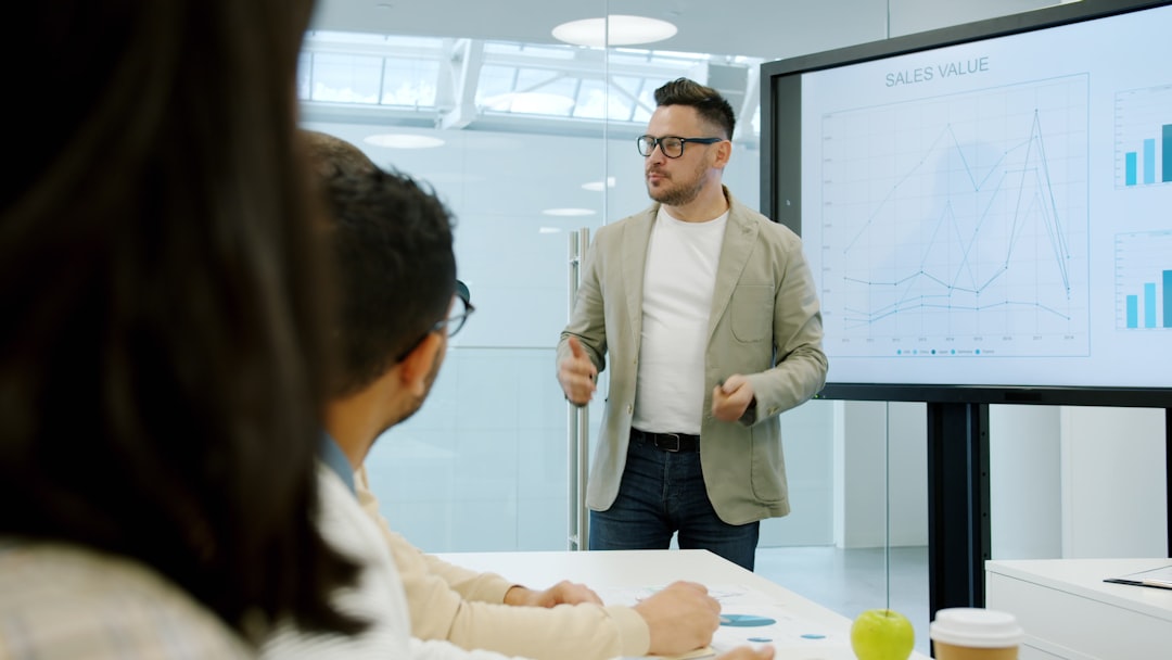 Economic data visualization on transparent screen, diverse professional team analyzing AI adoption metrics, dramatic overhead lighting, sleek conference room with city skyline backdrop