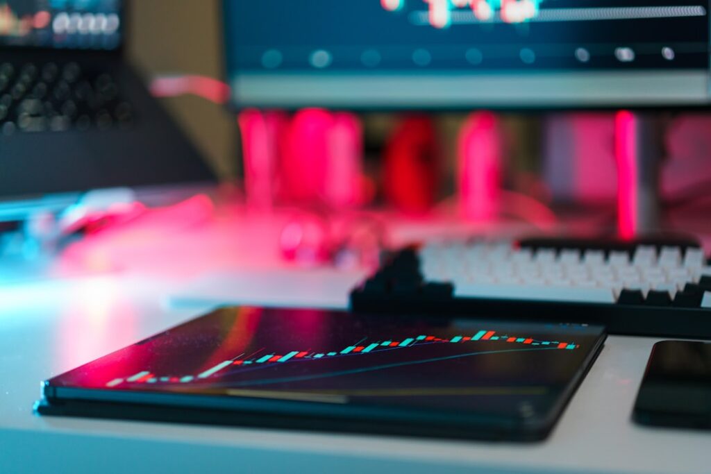 Exhausted professional slumped at sleek glass desk with holographic productivity charts glowing red, split-screen showing another worker celebrating, clean modern office with cool ambient lighting, AI