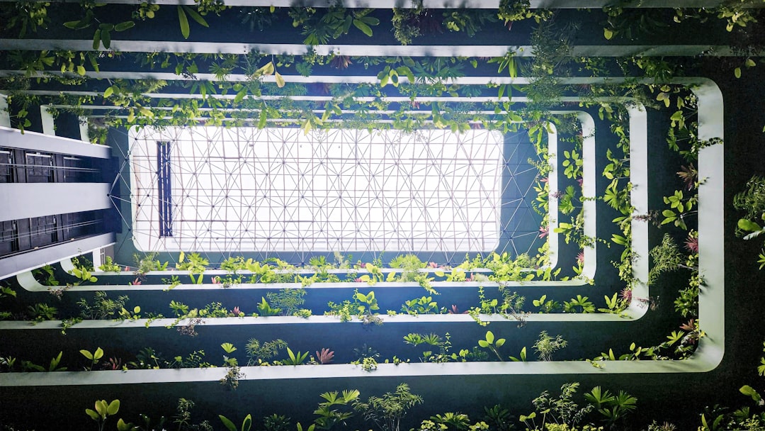 Autonomous robot arm tending vertical garden in sleek modern research lab, clean ambient lighting, holographic data displays, human-robot collaboration scene