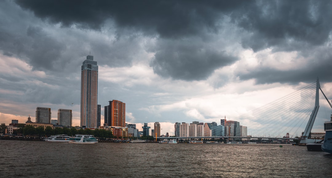 Diverse community members receiving emergency weather alerts on smartphones with city skyline and dramatic storm clouds in background