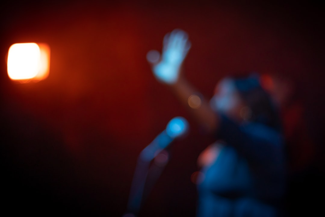 Young child silhouette interacting with glowing robotic toy in dim room, cool blue and warm orange contrast, soft bokeh, psychological tension mood