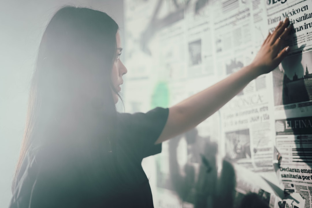Professional businesswoman analyzing holographic data charts in sleek modern office, blue ambient lighting, futuristic AI market dashboard, determined expression, glass walls, 2026 tech workspace