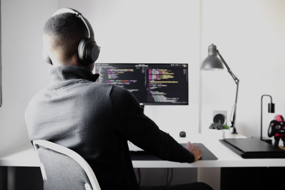 Futuristic game developer wearing sleek AR glasses, holographic game engine interface floating in dark ambient room, neon blue neural network visualization, professional tech workspace