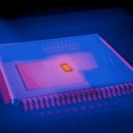 Close-up of glowing GPU microchip with holographic neural network overlay, cool blue ambient lighting, futuristic data center background, professional tech photography, sleek aesthetic