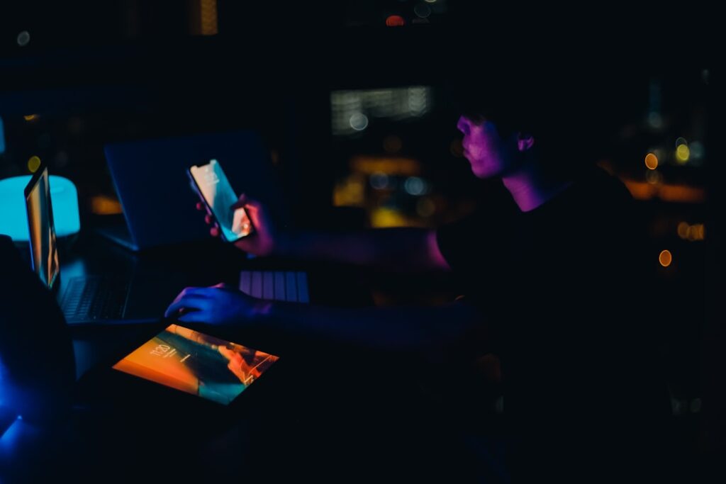 Close-up of diverse hands holding sleek smartphone with holographic privacy shield glowing, clean modern office background, cool blue ambient lighting, futuristic Apple-style minimalism, professional