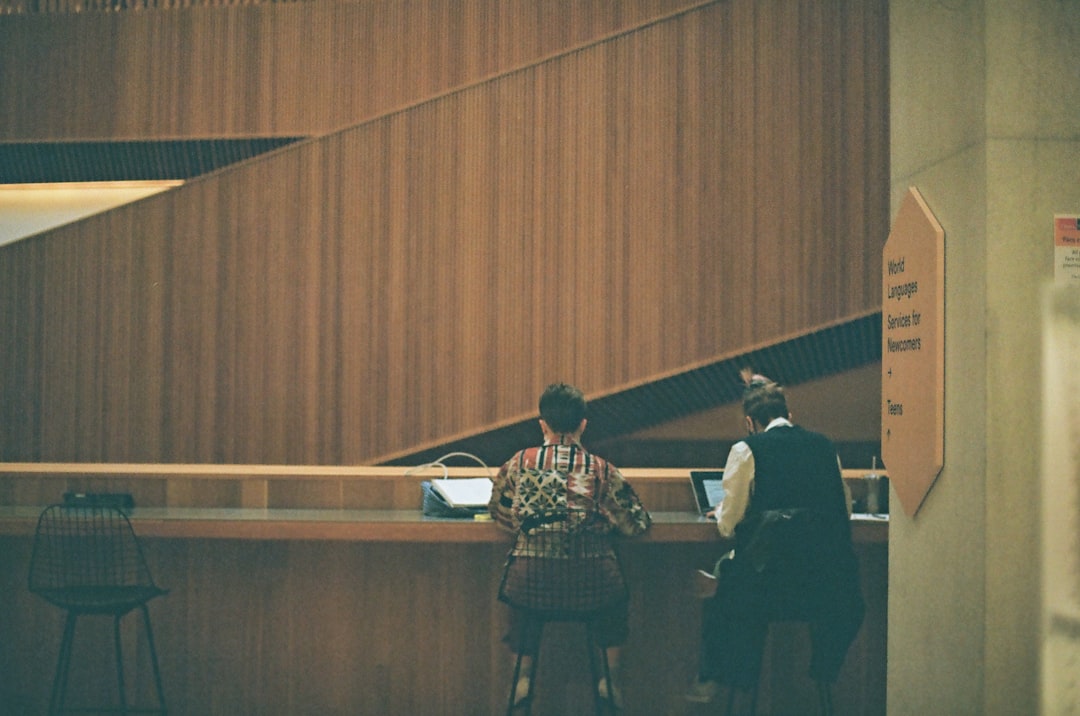 Diverse professionals accessing justice through modern tablet interfaces, clean modern office background, warm golden lighting, holographic legal aid interface, inclusive human element