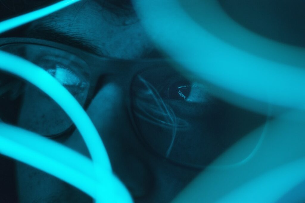 Futuristic medical AI concept, close-up of human eye with holographic neural network overlay, sleek ambient blue lighting, professional healthcare technology setting, digital diagnostics visualization