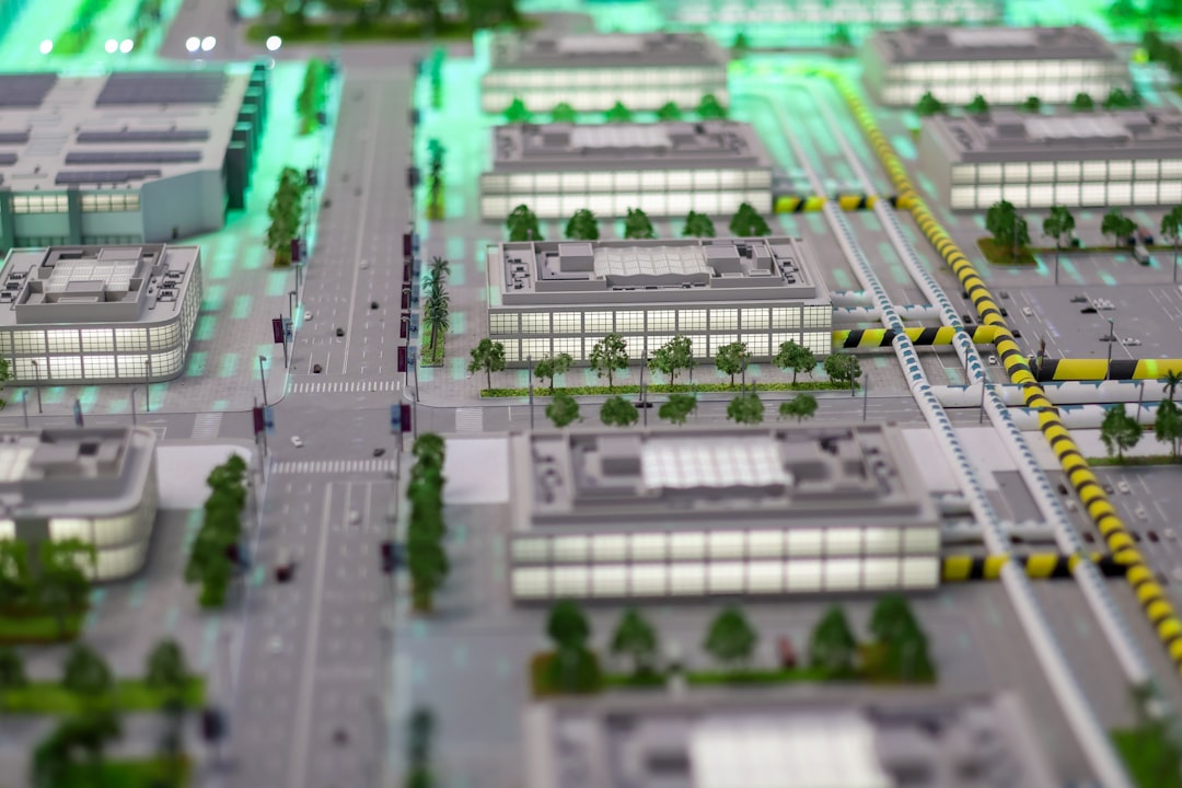 Aerial view of massive futuristic data center campus at twilight, glowing server rows, ambient blue-green lighting, neural network hologram overlay, professional tech aesthetic