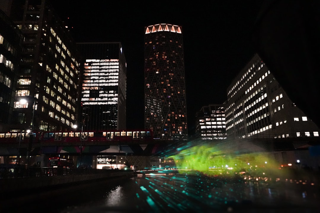 Futuristic financial district skyline overlaid with holographic data visualization and neural network graphs, sleek glass architecture, golden hour ambient lighting, professional investors analyzing A