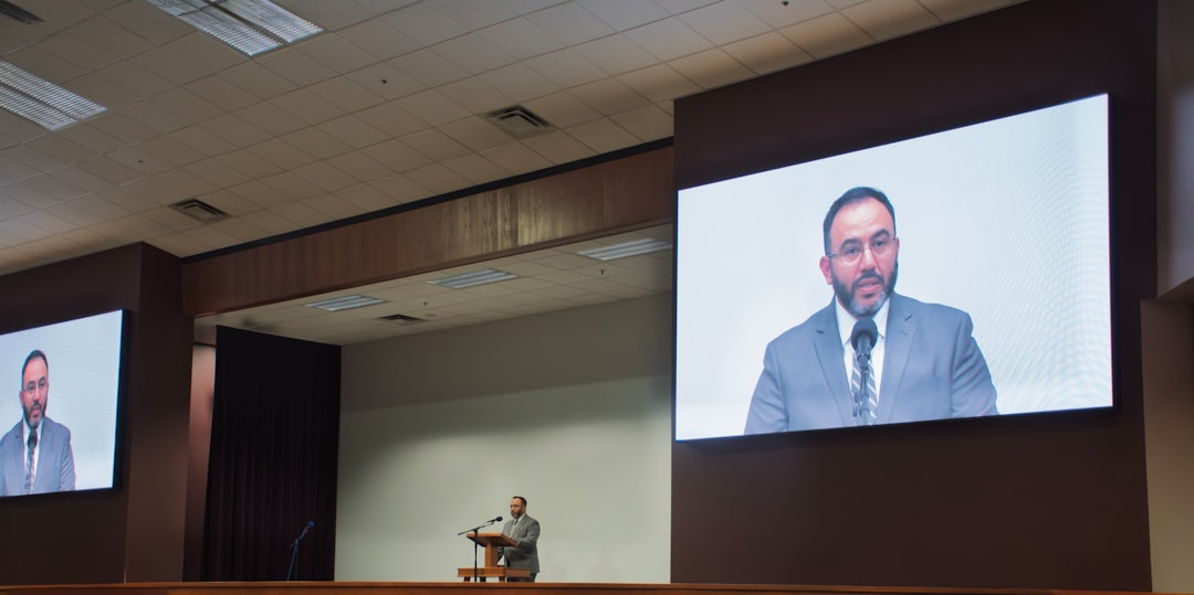 Dramatic courtroom with AI-powered holographic evidence display, cybersecurity dashboard projections, professional judge silhouette, sleek blue ambient lighting, justice and technology fusion concept,