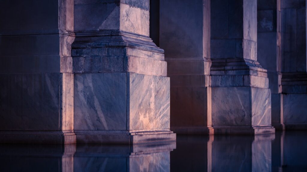 Crumbling classical university columns dissolving into digital pixels, holographic neural network overlay, dramatic blue ambient lighting, futuristic tech transformation concept, professional editoria