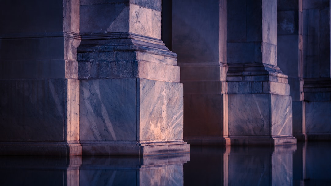 Crumbling classical university columns dissolving into digital pixels, holographic neural network overlay, dramatic blue ambient lighting, futuristic tech transformation concept, professional editoria