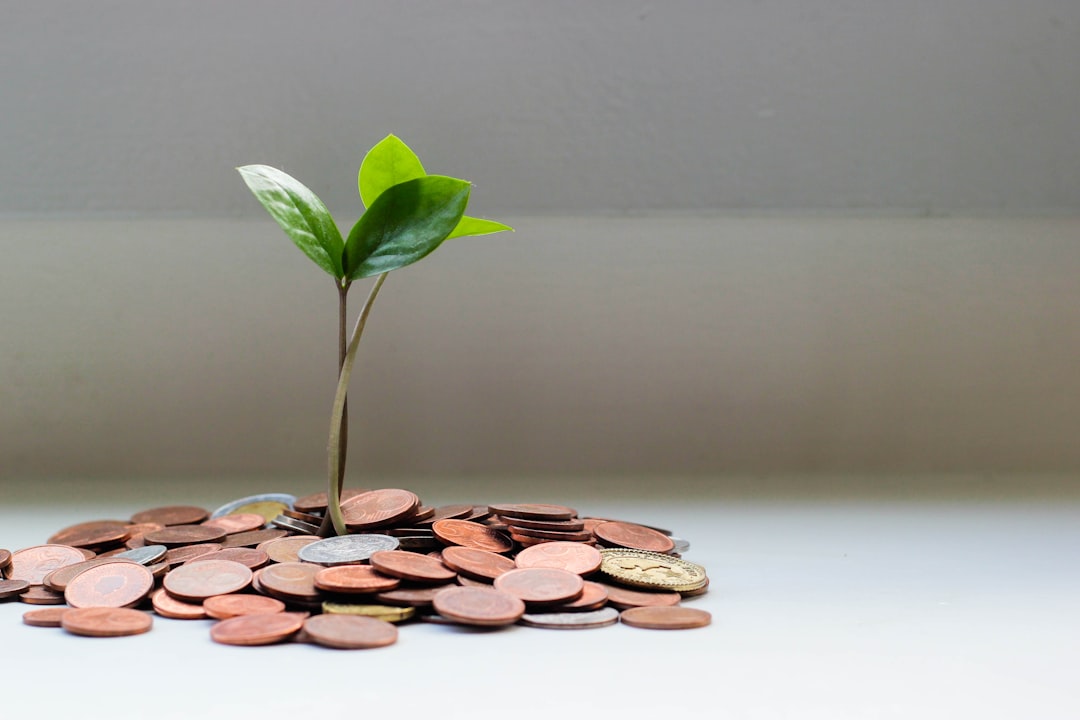 Sustainable financial growth concept, sleek holographic stock charts rising in ambient lit server room, professional investor examining data dashboard, green and gold futuristic interface, clean moder