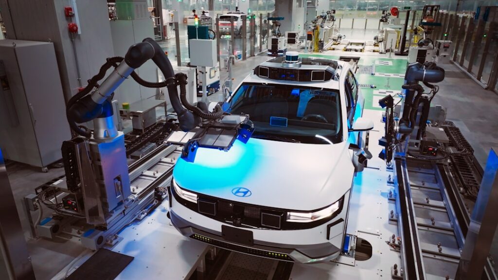 Futuristic autonomous robot arms in smart factory with holographic neural network visualization, ambient blue lighting, human engineer monitoring sleek control panel, industrial IoT sensors, clean mod
