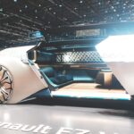 Futuristic Renault concept car interior with holographic AI dashboard display, neural network visualization overlay, ambient blue lighting, sleek minimalist design, professional automotive photography