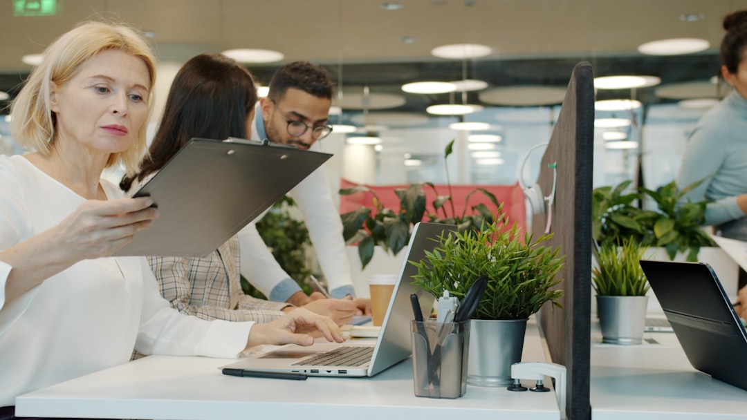 Close-up of diverse professional woman receiving personalized service from sleek tablet interface, soft ambient glow, real-time data streams, luxury hotel suite background with city lights