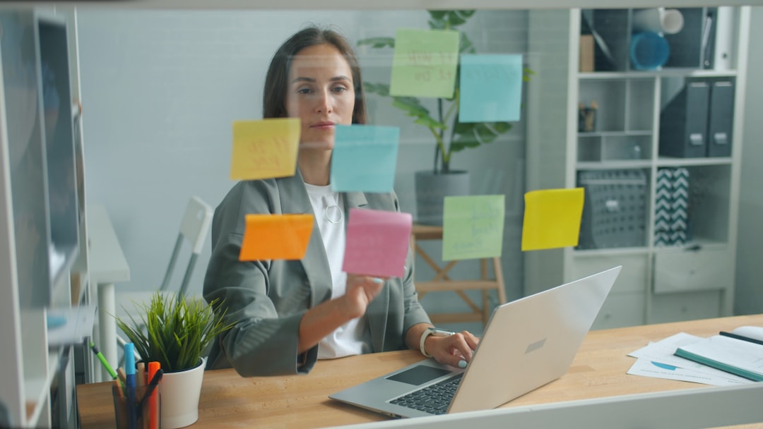 Clean modern office with holographic display showing generative AI art, professional woman interacting with floating interface, sleek ambient lighting, creative technology