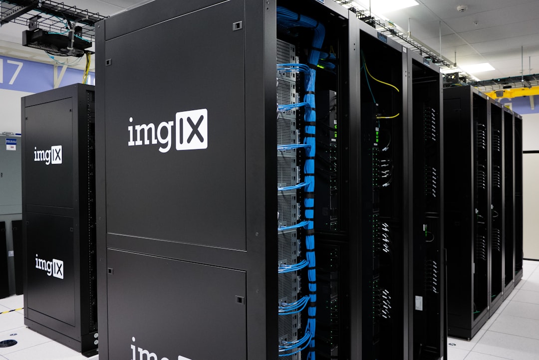 Autonomous robotics in data center corridor, human engineer collaborating with sleek AI agent interface, server room ambient glow, holographic dashboard overlay, professional cybersecurity aesthetic, 