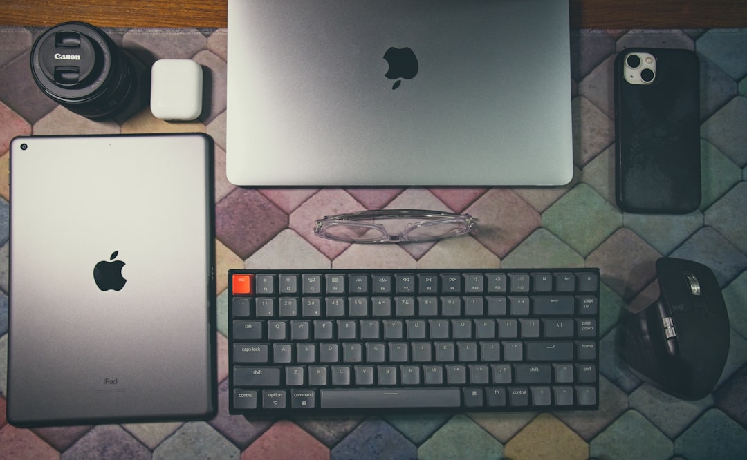 Apple ecosystem devices forming unified platform, holographic data streams connecting iPhone Mac iPad, clean modern office with professional developer, sleek ambient lighting