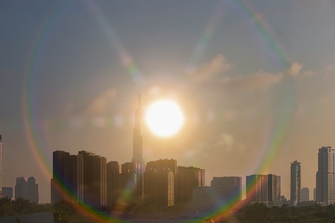 Dramatic sunrise over futuristic city skyline with transparent AI ethics hologram overlay, professional silhouette of confident business leader, warm hopeful ambient lighting, from crisis to opportuni