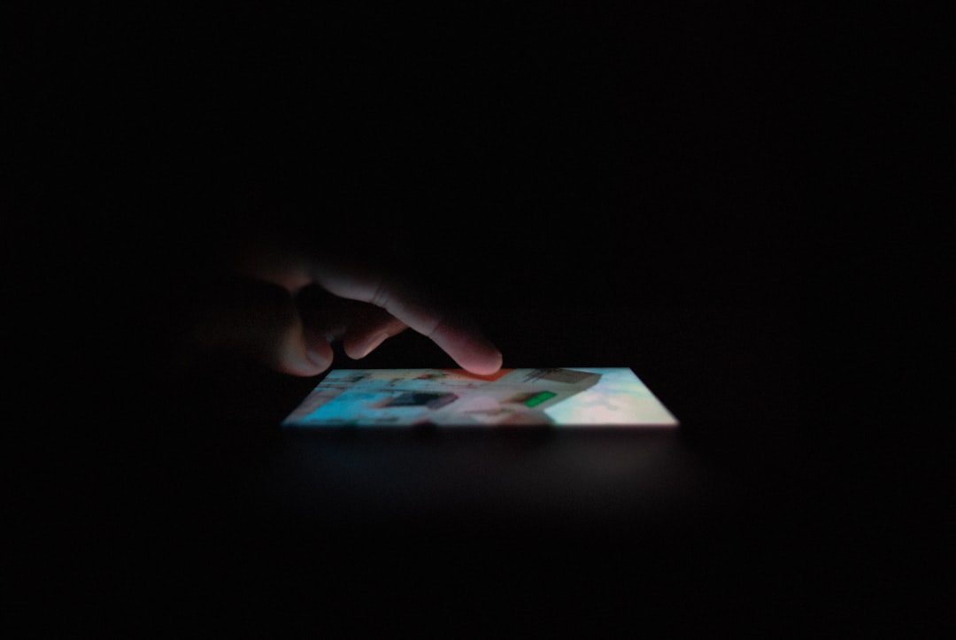 Dramatic low-angle view of human hand reaching toward glowing holographic regulatory document, AI brain visualization merging with legal framework, ambient golden and blue lighting, sleek minimalist s