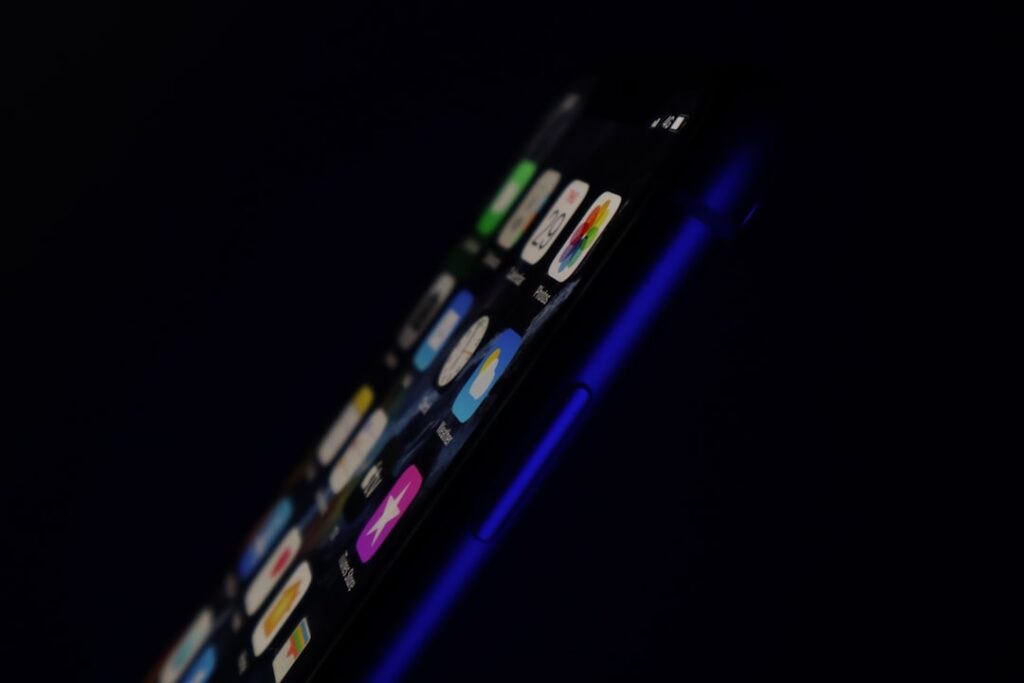 Futuristic close-up of sleek holographic AI interface merging with smartphone screen, soft ambient blue lighting, clean modern office background, human hand touching glowing neural network visualizati