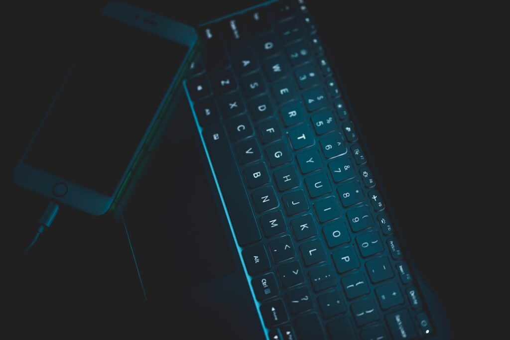 Futuristic professional workspace with human hands typing on holographic keyboard, robotic arm assisting nearby, sleek ambient lighting, neural network visualization floating above, clean modern offic